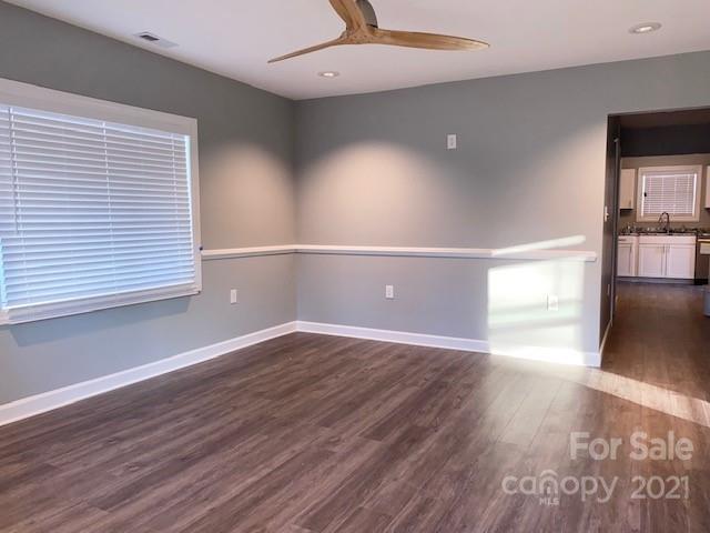 1599 Springdale Road Lancaster, SC 29720 - Photo 5 of 28 a view of an empty room with wooden floor and a window