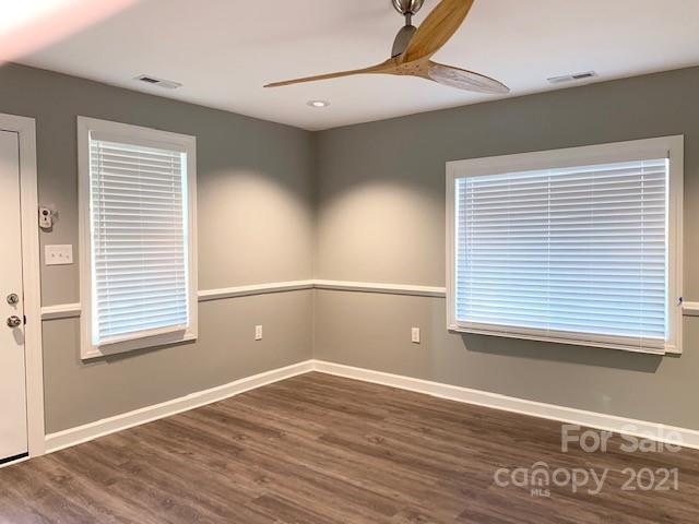 1599 Springdale Road Lancaster, SC 29720 - Photo 6 of 28 a view of an empty room with wooden floor and a window
