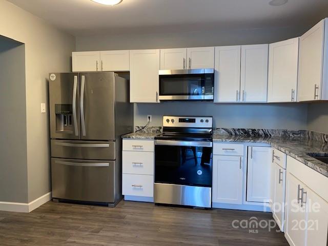 1599 Springdale Road Lancaster, SC 29720 - Photo 9 of 28 a kitchen with stainless steel appliances granite countertop a refrigerator stove a sink and a microwave
