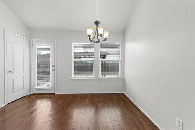 a view of door with hardwood floor
