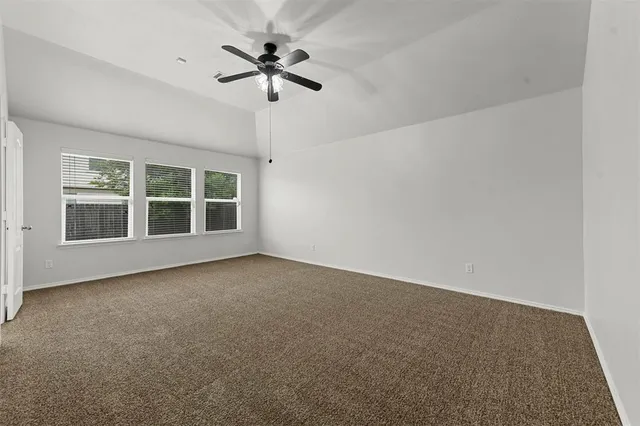 an empty room with a empty space and a ceiling fan