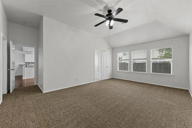 a view of a room with a ceiling fan
