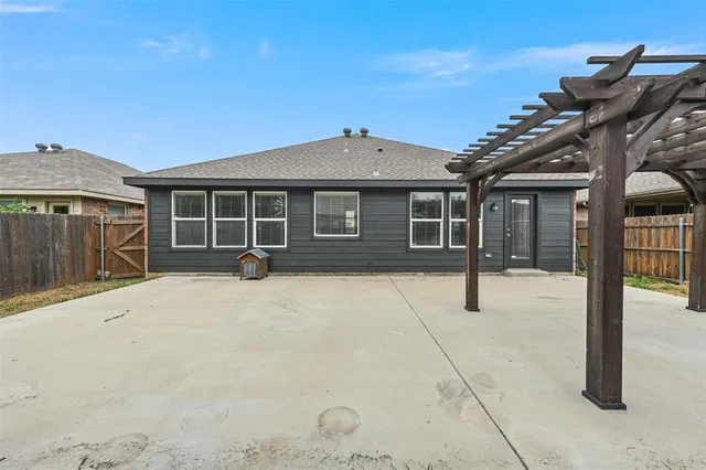a front view of a house with a wooden fence