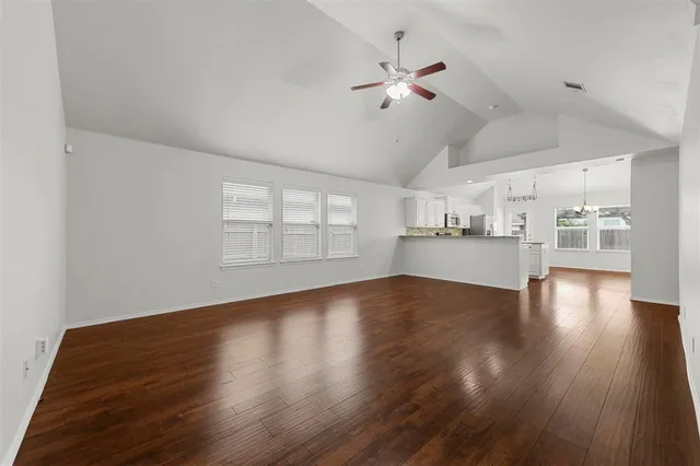 a view of a kitchen with wooden floor and a kitchen