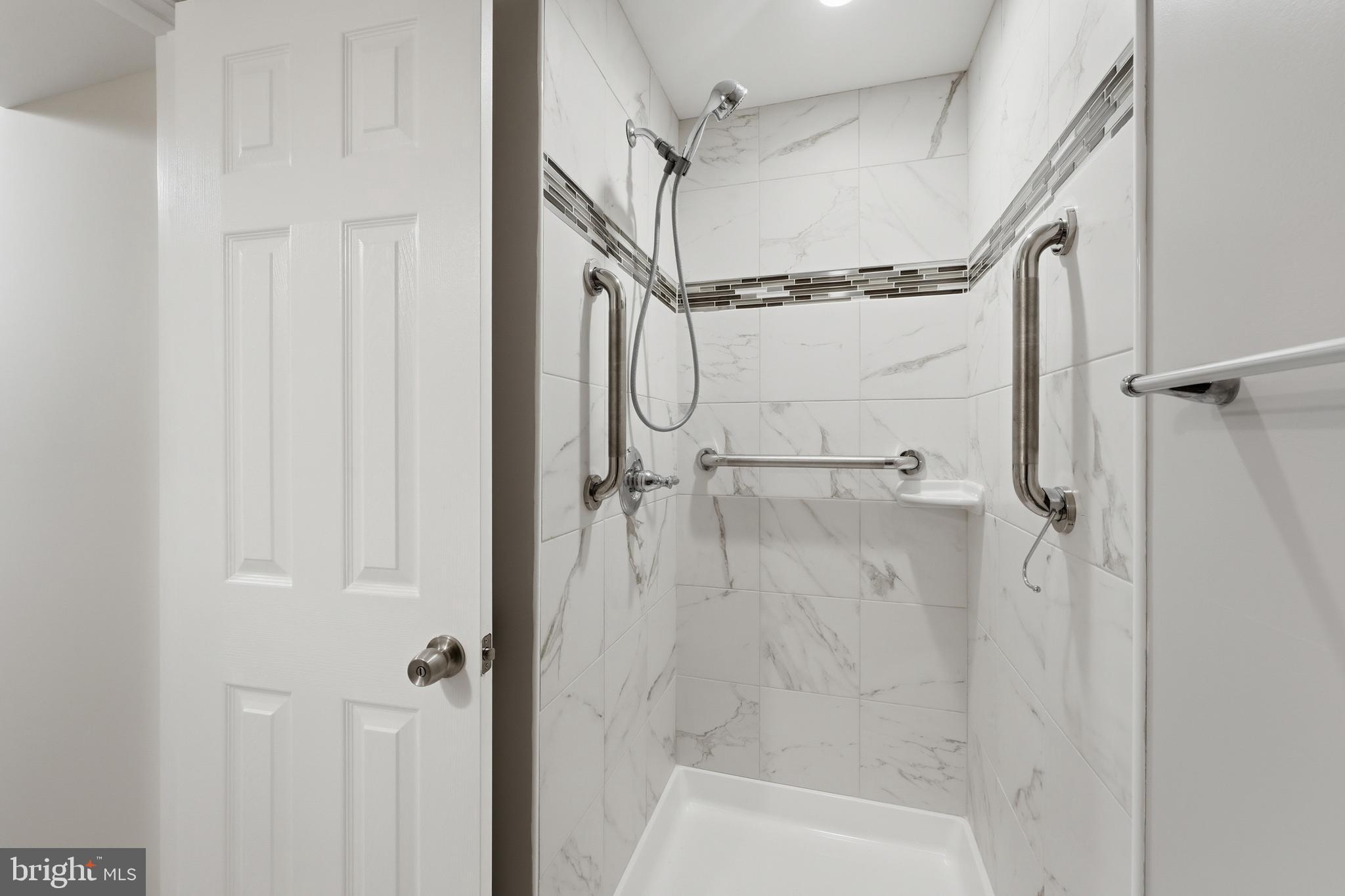 228 Northwest Terrace Silver Spring, MD 20901 - Photo 55 of 70 a bathroom with a glass shower door