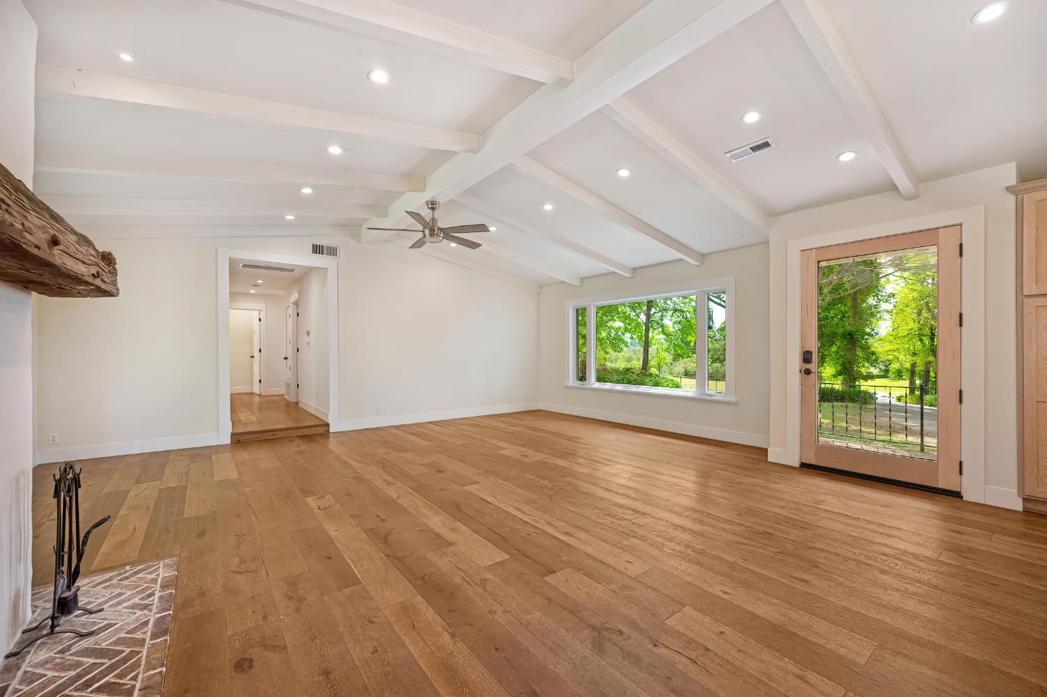 8495 Chili Hill Road Newcastle, CA 95658 - Photo 12 of 56 an empty room with wooden floor and windows