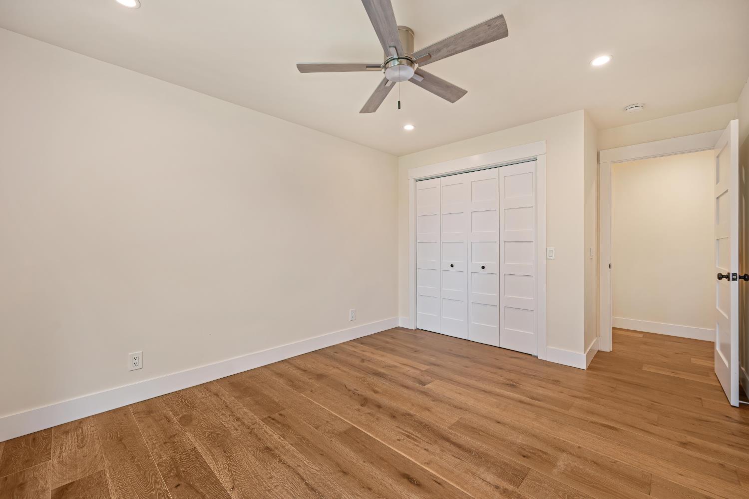 8495 Chili Hill Road Newcastle, CA 95658 - Photo 21 of 56 an empty room with wooden floor and ceiling fan