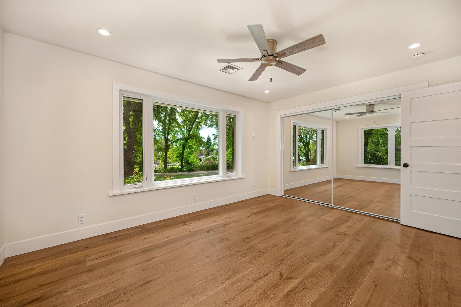 8495 Chili Hill Road Newcastle, CA 95658 - Photo 25 of 56 a view of an empty room with a window and wooden floor