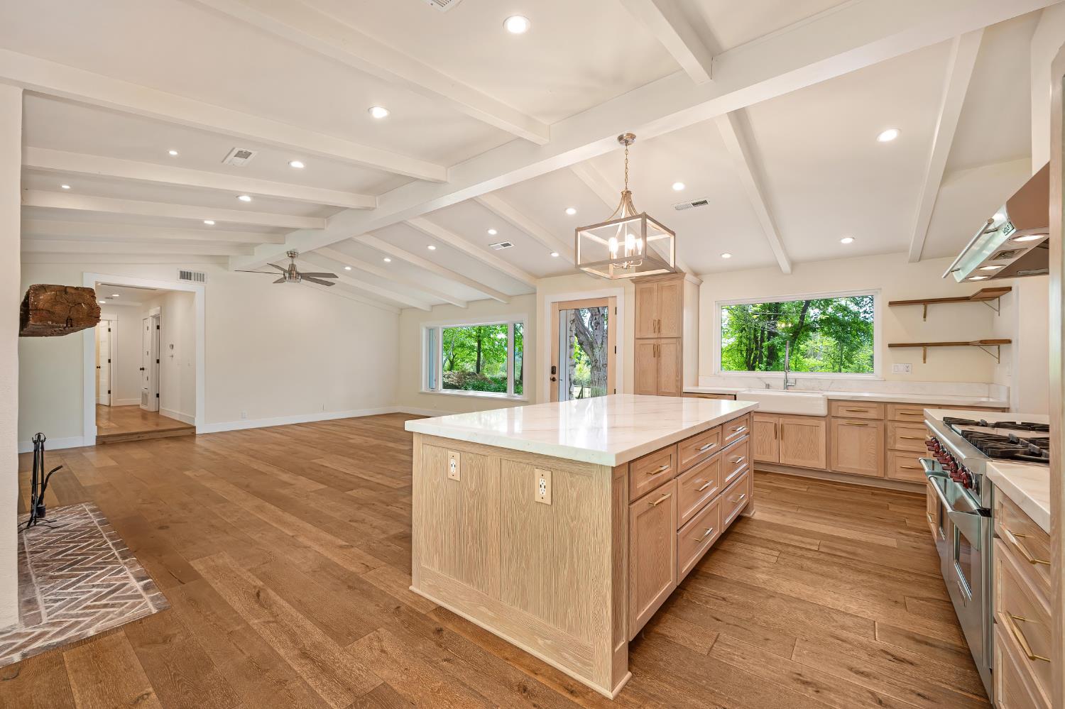 8495 Chili Hill Road Newcastle, CA 95658 - Photo 5 of 56 a large kitchen with kitchen island a stove a sink a refrigerator and a counter space