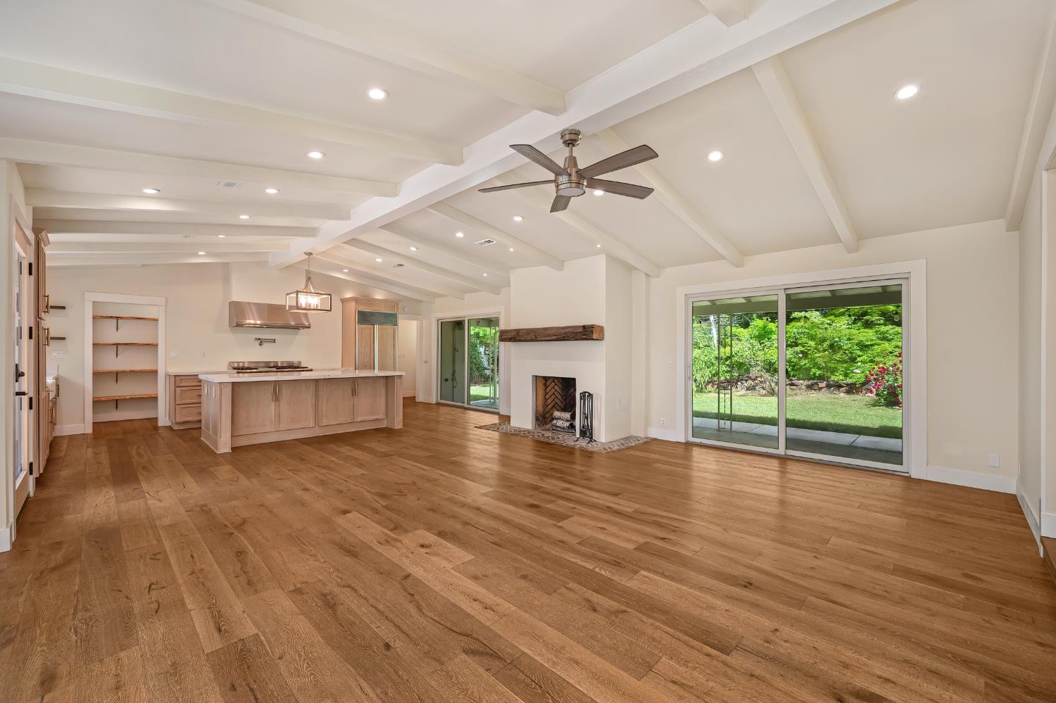 8495 Chili Hill Road Newcastle, CA 95658 - Photo 6 of 56 a view of a room with wooden floors and kitchen view