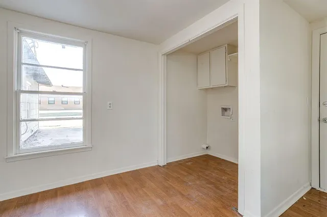 a view of a kitchen with wooden floor and a large window