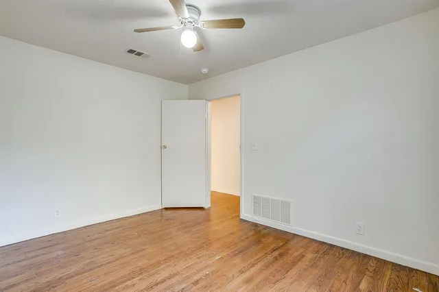 a view of a livingroom with wooden floor and window