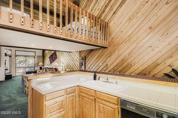 a view of a kitchen with furniture and wooden floor