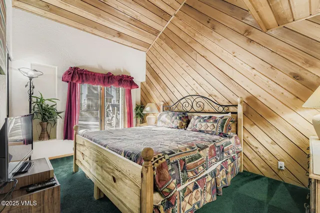 a bed sitting in a bedroom next to a window