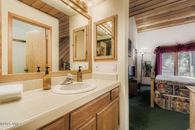 a bedroom with a bed and a painting on the wall