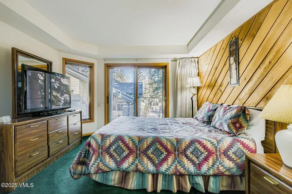 a bedroom with two beds and a dresser