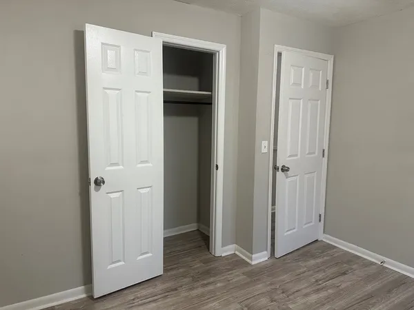 a view of a hallway with wooden floor