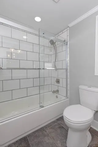 a bathroom with a toilet and shower
