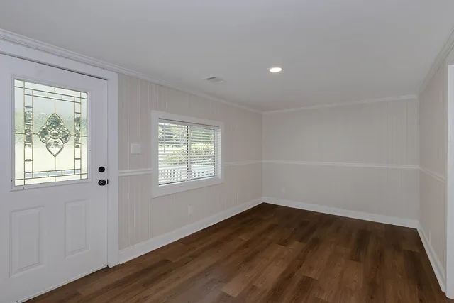 wooden floor in an empty room with a window