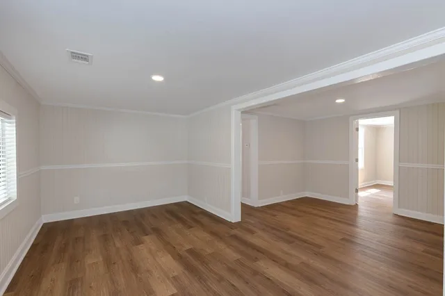 a view of a room with wooden floor and white walls