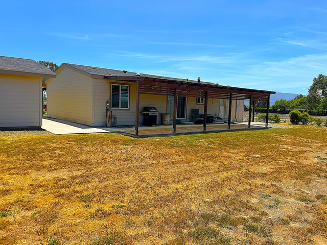 a house view with swimming pool in front of it