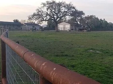 a view of a green yard next to a lake view