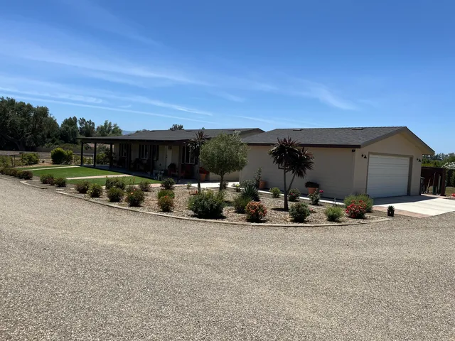 a view of a house with patio and sitting area