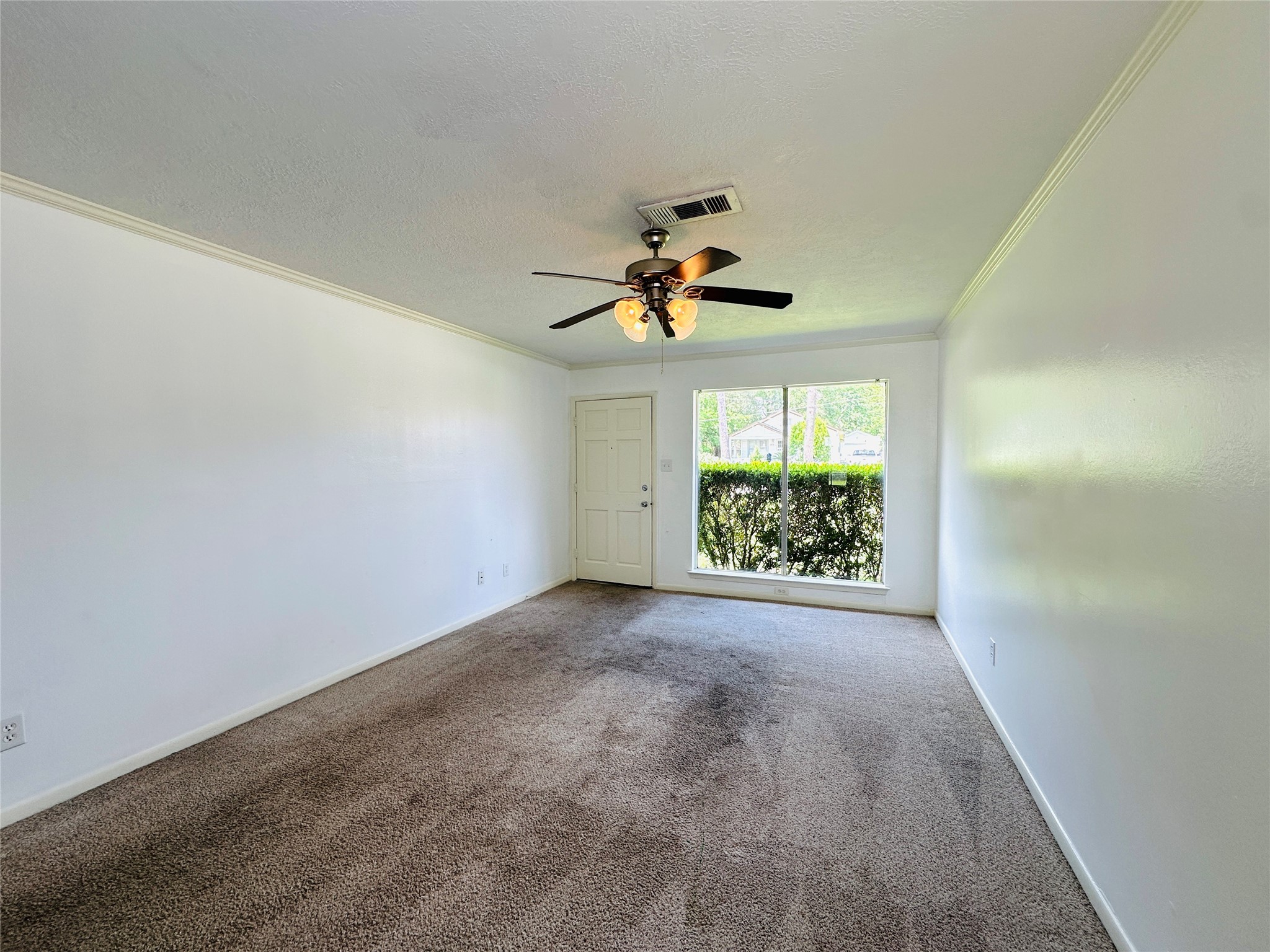 1011 Mccall Avenue Conroe, TX 77301 - Photo 13 of 15 en view of room with window and ceiling fan