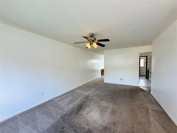 a view of a livingroom with a ceiling fan and window