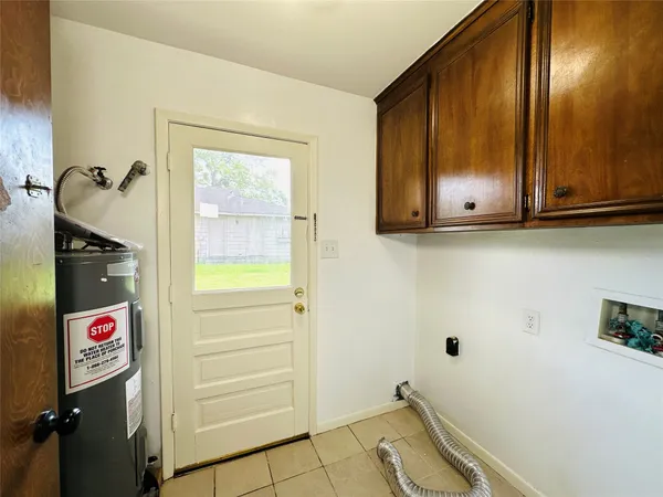 a view of an entryway with wooden cabinet