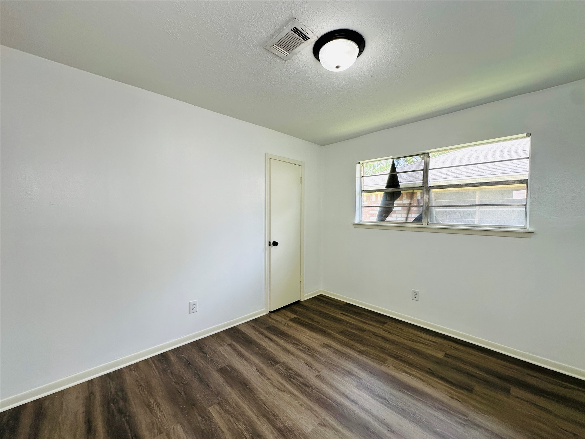 1011 Mccall Avenue Conroe, TX 77301 - Photo 10 of 15 an empty room with windows