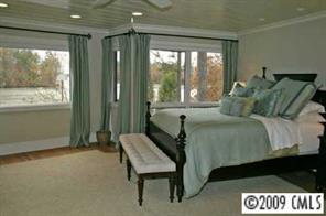 15131 Birling Road Charlotte, NC 28278 - Photo 3 of 12 a bed sitting in a bedroom next to a window