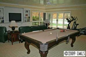 15131 Birling Road Charlotte, NC 28278 - Photo 5 of 12 a room with furniture pool table flat screen tv and windows