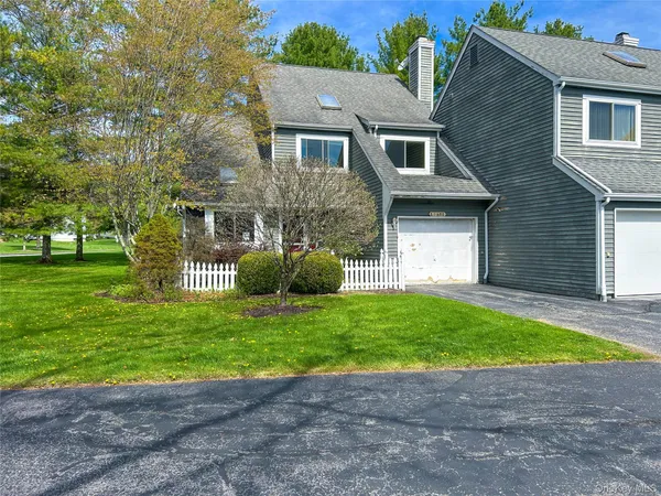 a front view of a house with a garden and yard