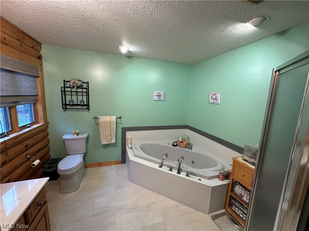 4308 Lyntz Road Warren, OH 44481 - Photo 9 of 34 Bathroom with tile floors, toilet, and a textured ceiling