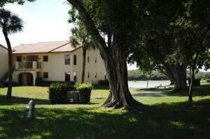 2650 Greenwood Terrace, Unit 125 Boca Raton, FL 33431 - Photo 18 of 25 front view of a house with a yard