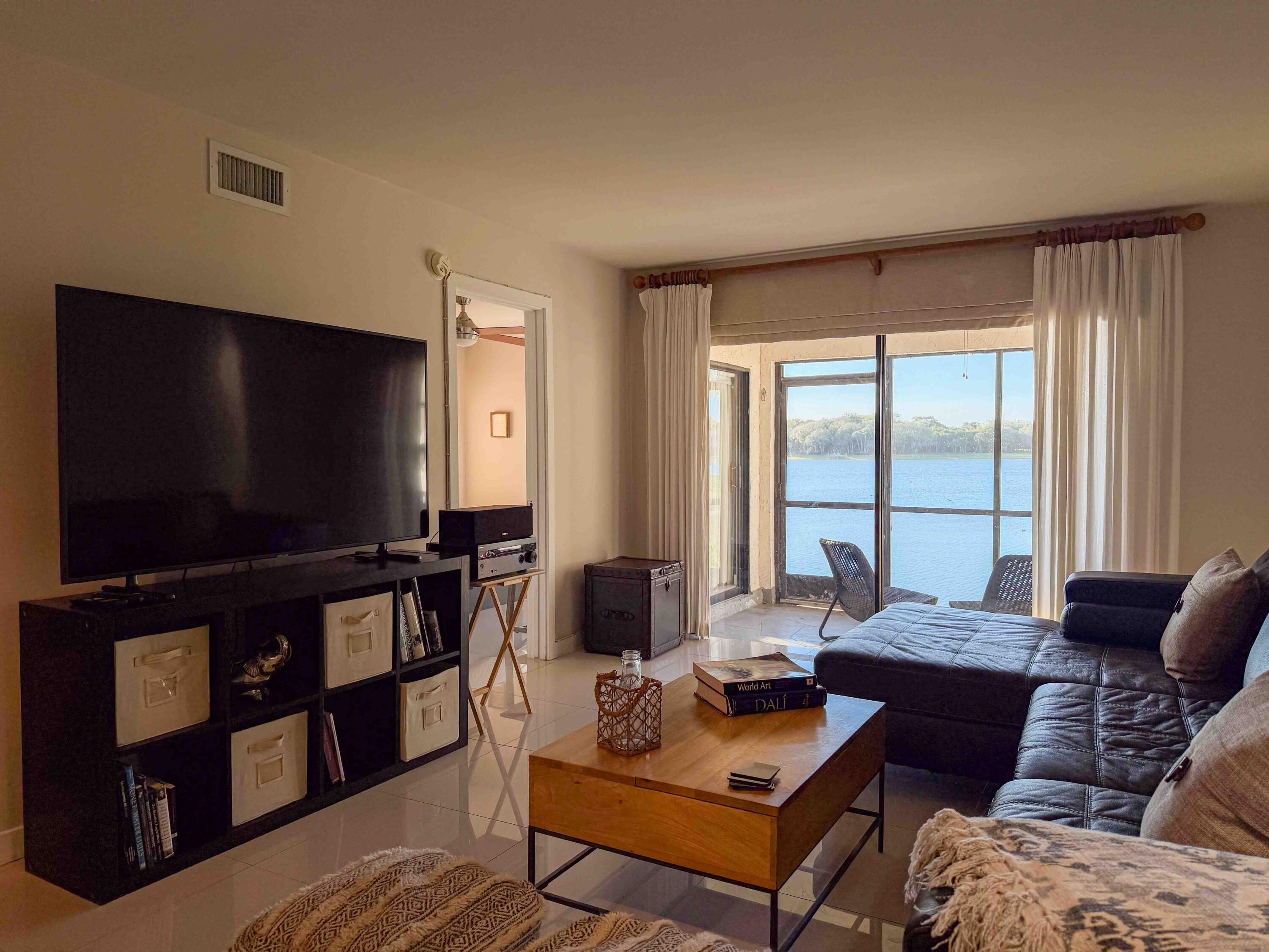 2650 Greenwood Terrace, Unit 125 Boca Raton, FL 33431 - Photo 2 of 25 a living room with furniture and a flat screen tv