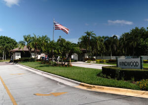 2650 Greenwood Terrace, Unit 125 Boca Raton, FL 33431 - Photo 23 of 25 a front view of a house with a yard and trees