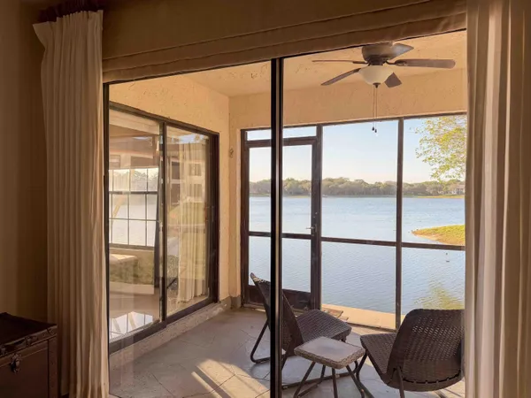 a view of a room with furniture and wooden floor