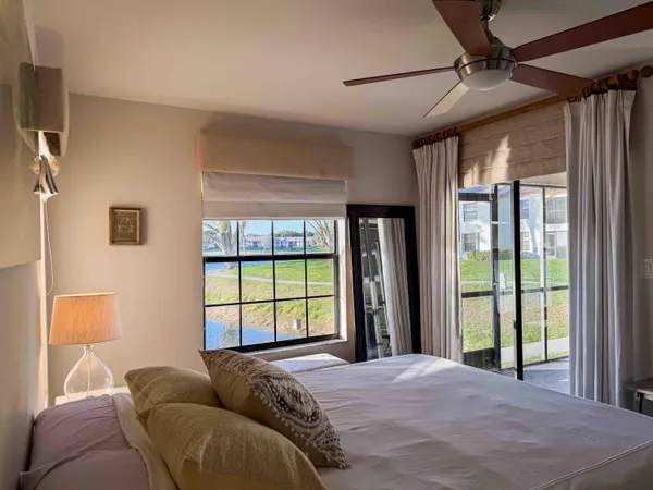 a bed sitting in a bedroom next to a window