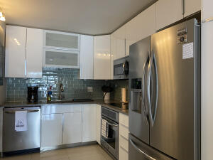 2650 Greenwood Terrace, Unit 125 Boca Raton, FL 33431 - Photo 7 of 25 a kitchen with stainless steel appliances a refrigerator sink and cabinets
