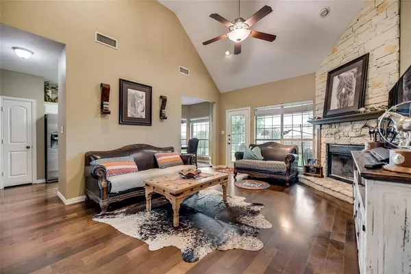 a living room with furniture fireplace and a large window