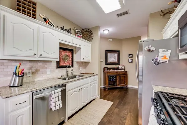 a kitchen with a sink stove and cabinets