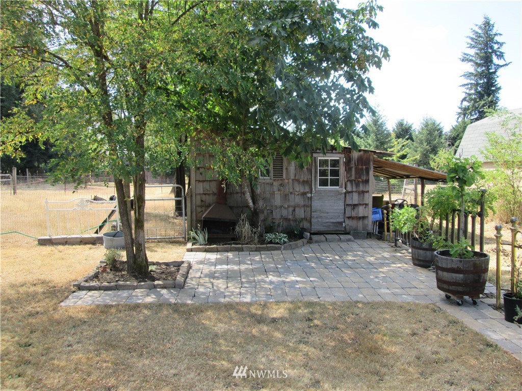19039 Loganberry Street Southwest Rochester, WA 98579 - Photo 14 of 25 a view of a house with backyard and a tree