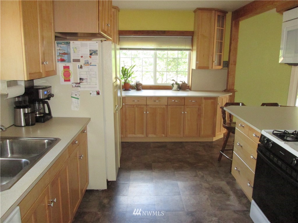 19039 Loganberry Street Southwest Rochester, WA 98579 - Photo 9 of 25 a kitchen with a refrigerator and a sink