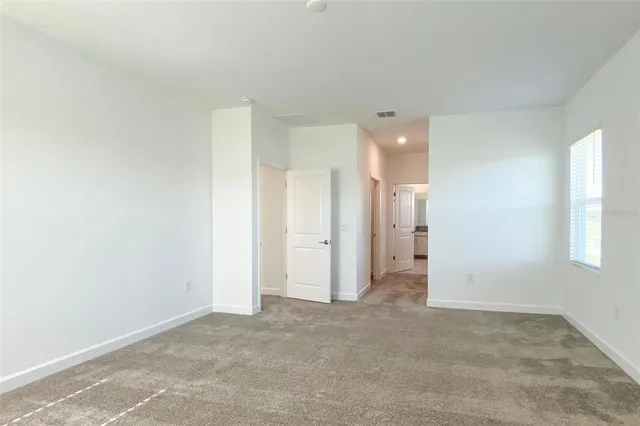 a view of a big room with windows and closet