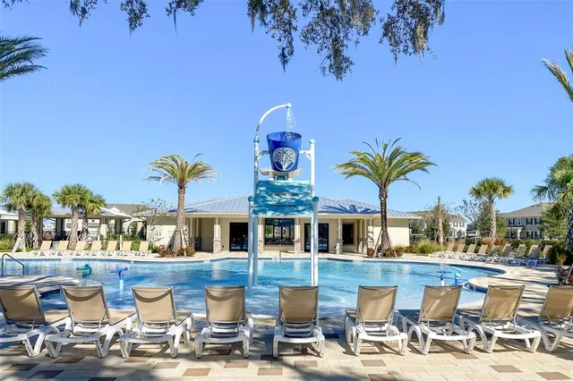a view of a swimming pool with outdoor seating