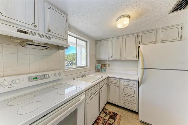 a utility room with cabinets washer and dryer