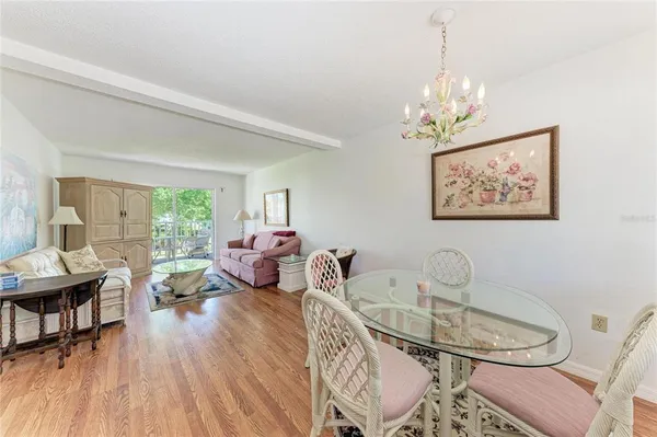 a living room with furniture a dining table and a window