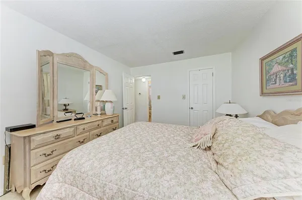 a bedroom with a bed and a dresser